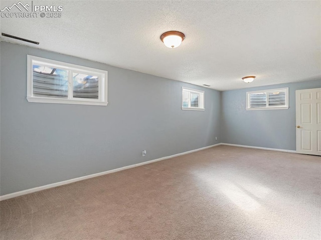 basement featuring carpet floors and a textured ceiling