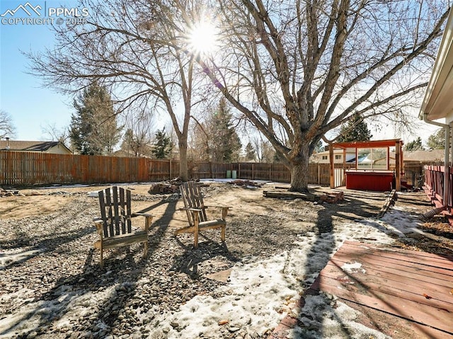 view of yard featuring a hot tub and a wooden deck