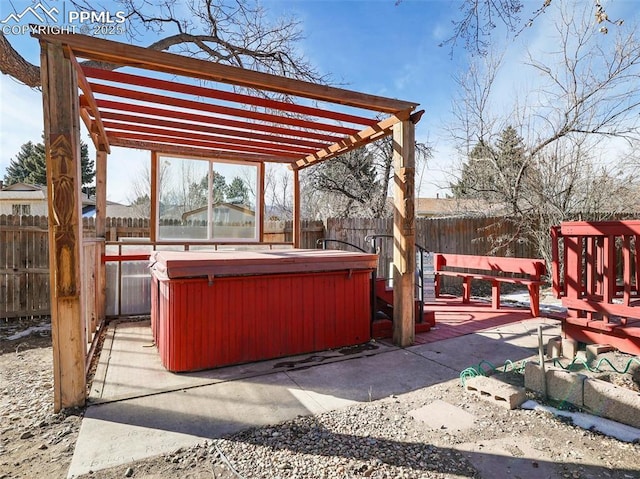 view of patio / terrace with a hot tub and a pergola