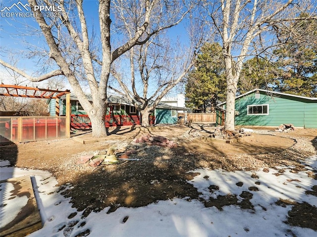 snowy yard featuring a pergola