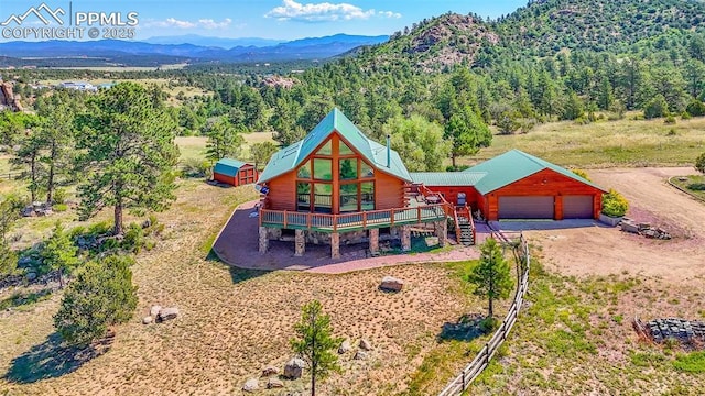 birds eye view of property featuring a mountain view