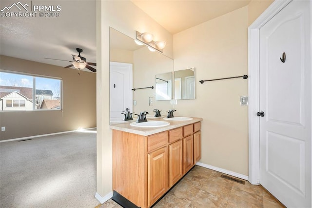 bathroom with ceiling fan and vanity