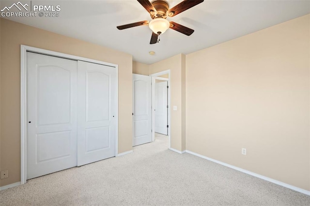 unfurnished bedroom with light carpet, ceiling fan, and a closet