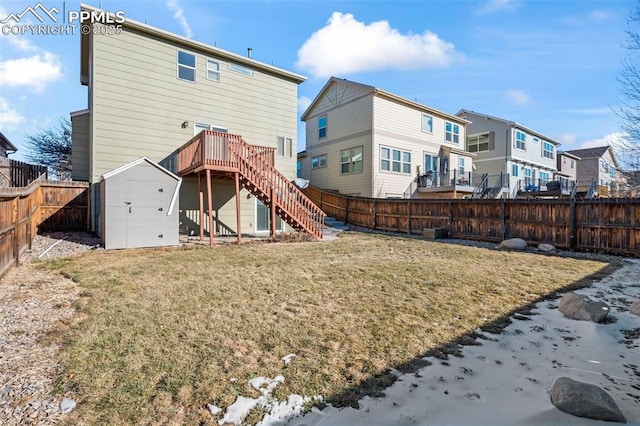 rear view of property with a yard and a shed