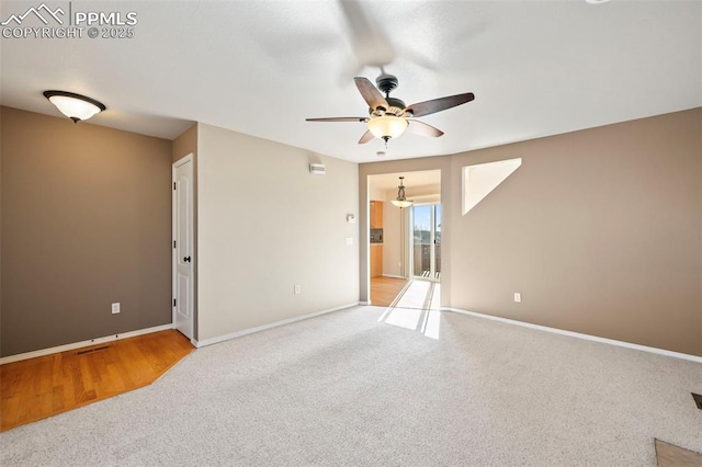 unfurnished room with ceiling fan and light carpet