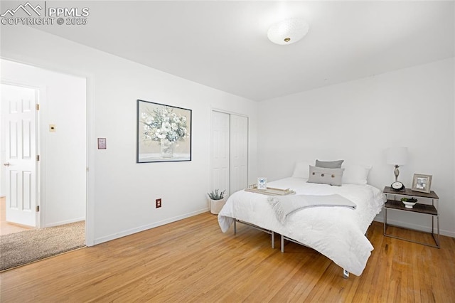 bedroom with a closet and hardwood / wood-style flooring