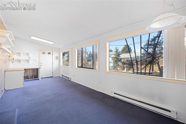 interior space featuring baseboard heating, dark carpet, and vaulted ceiling