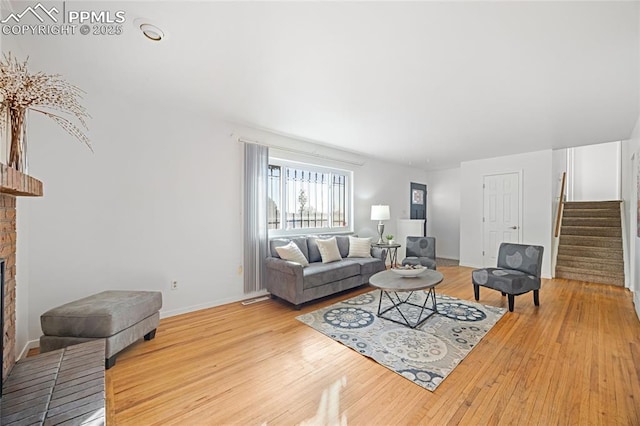 living room with a fireplace and hardwood / wood-style floors