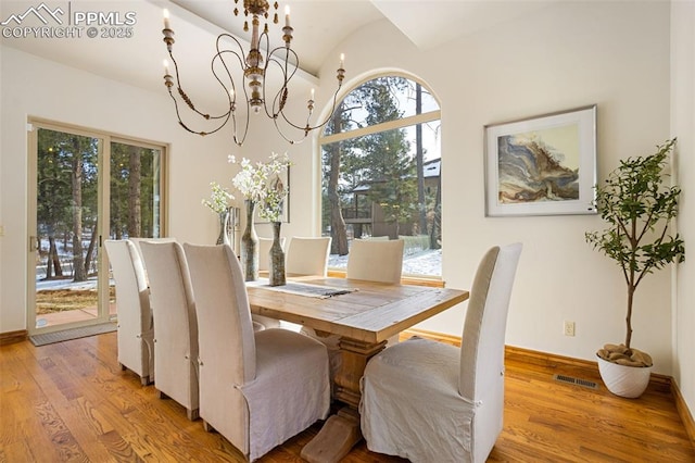 dining space featuring a notable chandelier and light hardwood / wood-style flooring