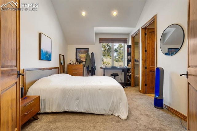 carpeted bedroom with lofted ceiling