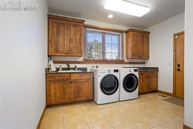 washroom featuring cabinets, light tile patterned flooring, sink, and independent washer and dryer