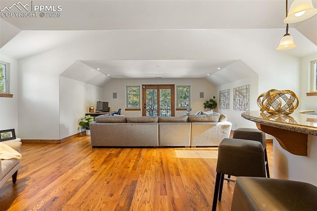 living room with hardwood / wood-style floors and vaulted ceiling