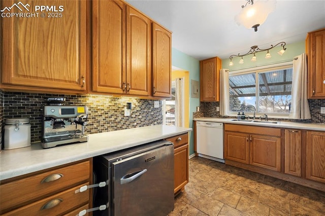 kitchen with sink, stainless steel dishwasher, decorative backsplash, and dishwasher