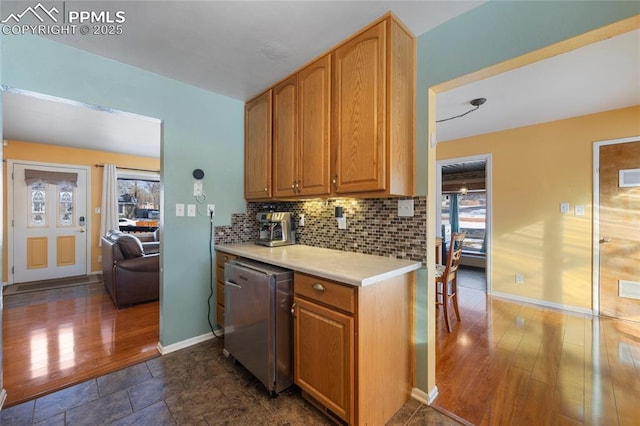 kitchen featuring a wealth of natural light, fridge, and tasteful backsplash