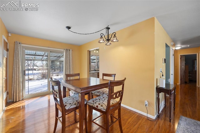 dining room featuring a notable chandelier and hardwood / wood-style floors