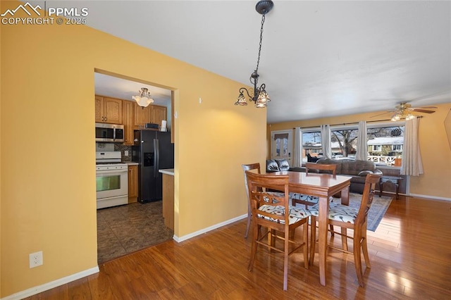 dining area featuring ceiling fan and dark wood-type flooring