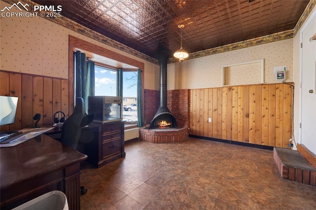 office with wooden walls and a wood stove