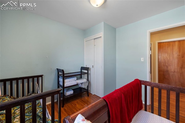 bedroom featuring a closet and dark hardwood / wood-style flooring