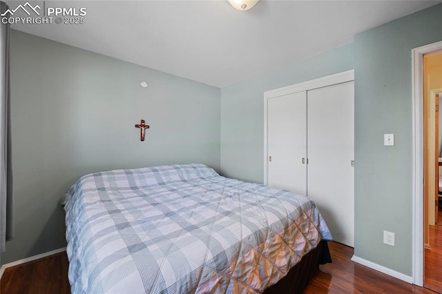 bedroom featuring a closet and dark hardwood / wood-style flooring