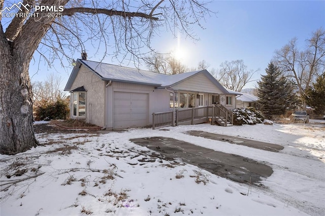 view of front of home with a garage and a porch