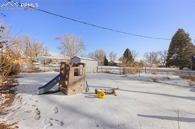 snowy yard with a playground