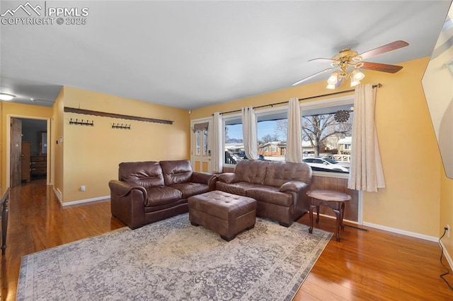 living room featuring hardwood / wood-style floors and ceiling fan