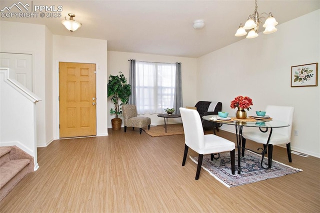 dining space with an inviting chandelier and wood-type flooring