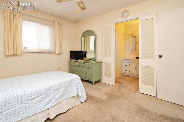 carpeted bedroom featuring connected bathroom and ceiling fan