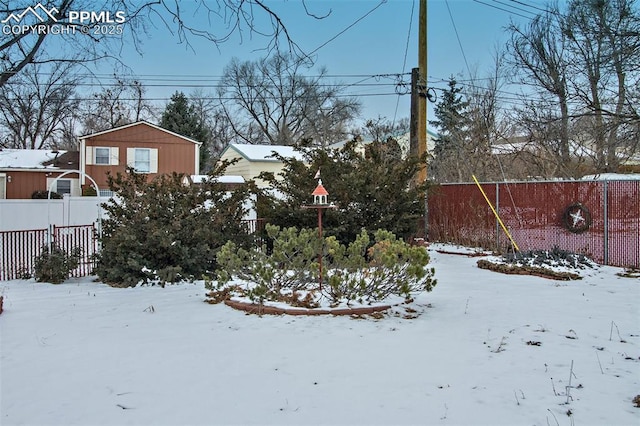 view of yard layered in snow