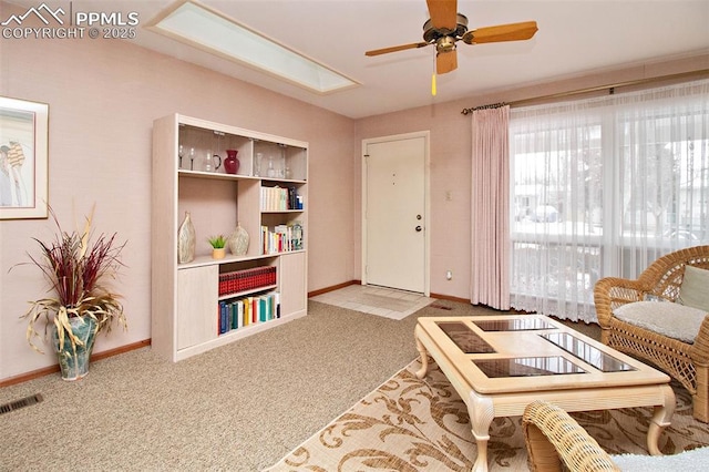 living room with light colored carpet and ceiling fan