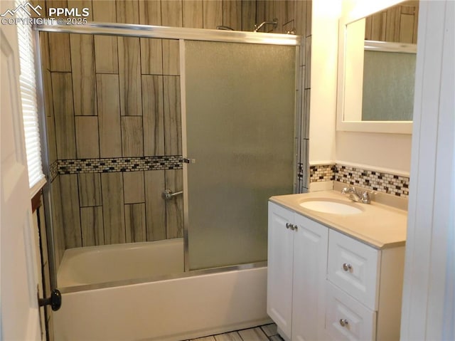 bathroom with bath / shower combo with glass door, backsplash, and vanity