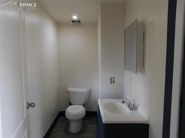 bathroom with toilet and vanity