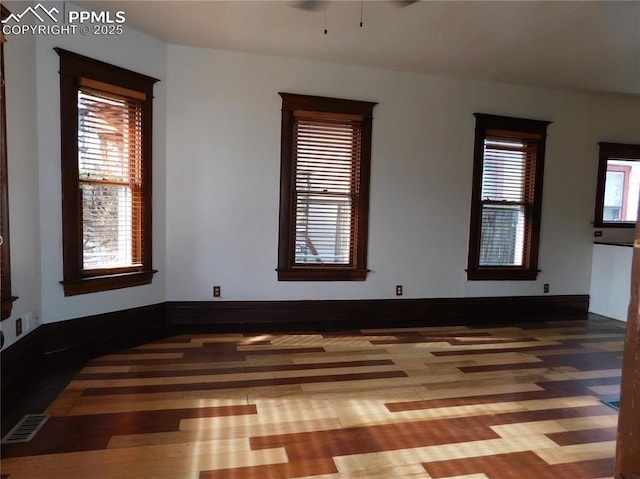 empty room featuring ceiling fan and hardwood / wood-style floors