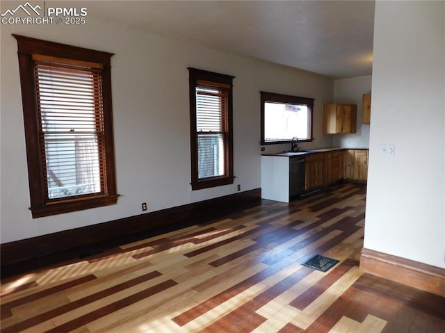 unfurnished living room featuring sink and dark hardwood / wood-style flooring