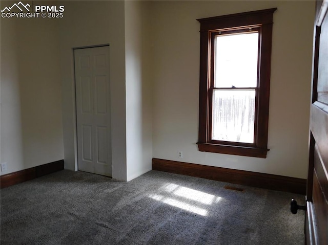 unfurnished bedroom featuring dark colored carpet