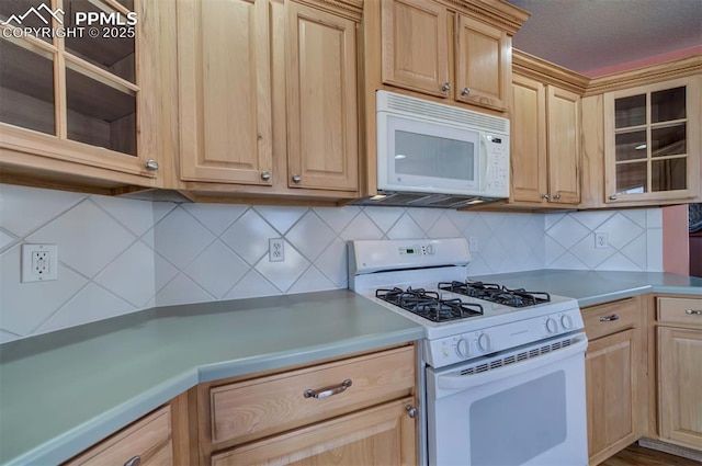 kitchen with light brown cabinetry, white appliances, and decorative backsplash