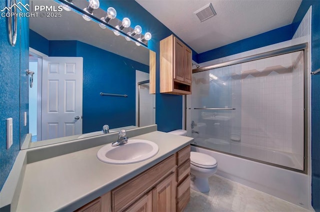 full bathroom featuring vanity, toilet, combined bath / shower with glass door, and a textured ceiling