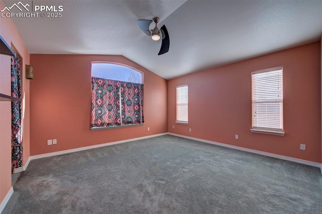 spare room featuring vaulted ceiling, ceiling fan, and carpet flooring