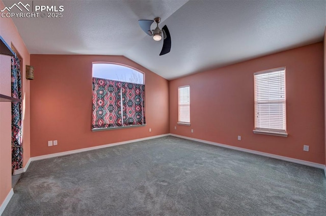 carpeted empty room featuring lofted ceiling and ceiling fan