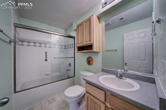 full bathroom featuring bath / shower combo with glass door, vanity, a textured ceiling, and toilet