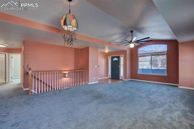 unfurnished living room with carpet floors, vaulted ceiling, and a notable chandelier