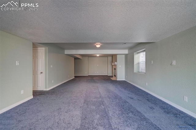 interior space featuring dark carpet and a textured ceiling