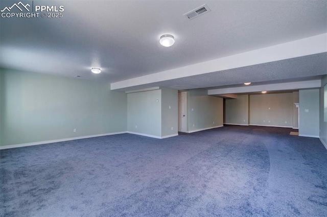 basement featuring dark colored carpet