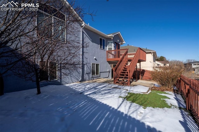 snow covered property featuring a deck