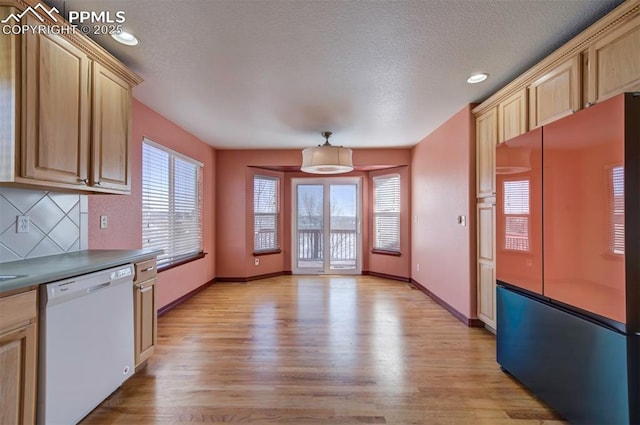 kitchen featuring refrigerator, dishwasher, decorative backsplash, light hardwood / wood-style floors, and light brown cabinets