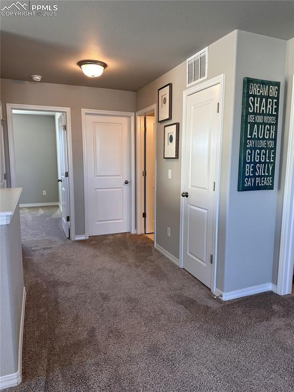 hallway with carpet floors