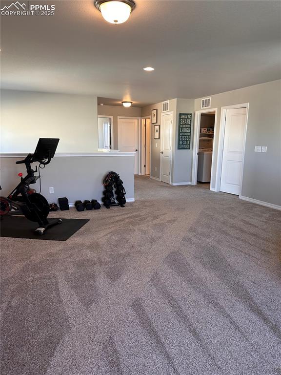 interior space with washer / clothes dryer and carpet flooring