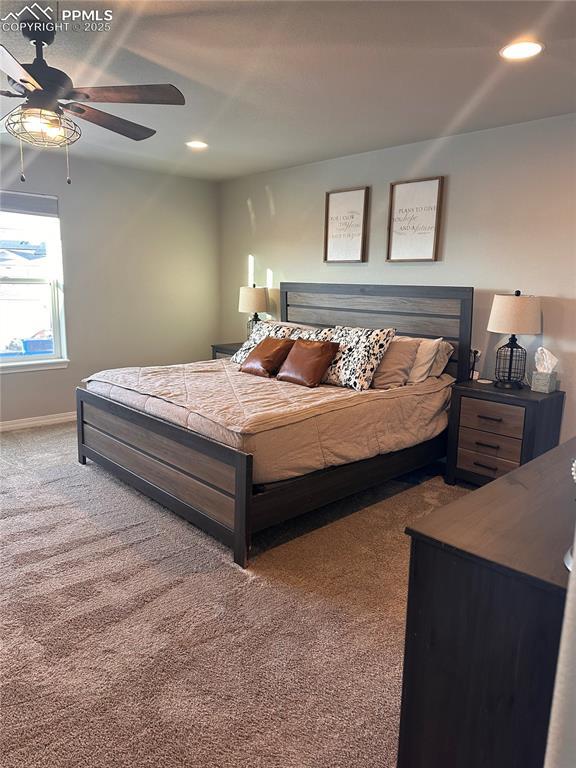 carpeted bedroom with ceiling fan