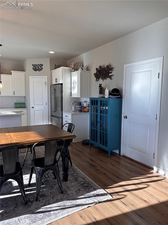 dining space with dark hardwood / wood-style floors