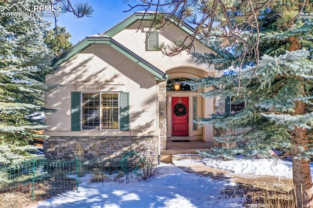 view of snow covered property entrance